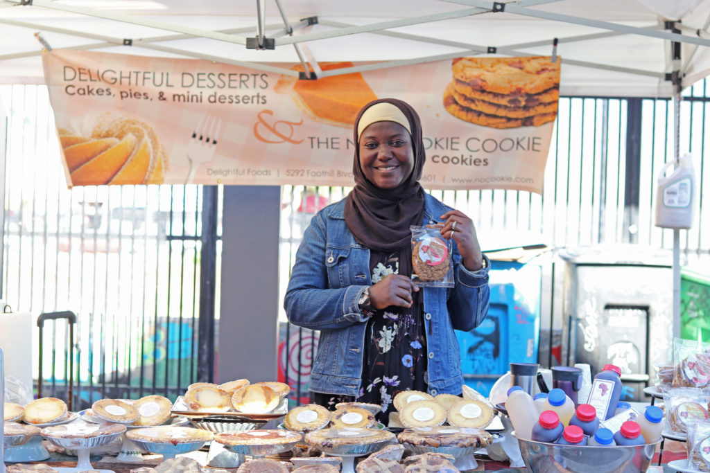 Delightful Foods booth with staff holding cookies